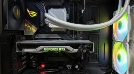 Detailed view of a gaming PC build featuring a GeForce RTX graphics card and RGB lighting in a sleek black case.